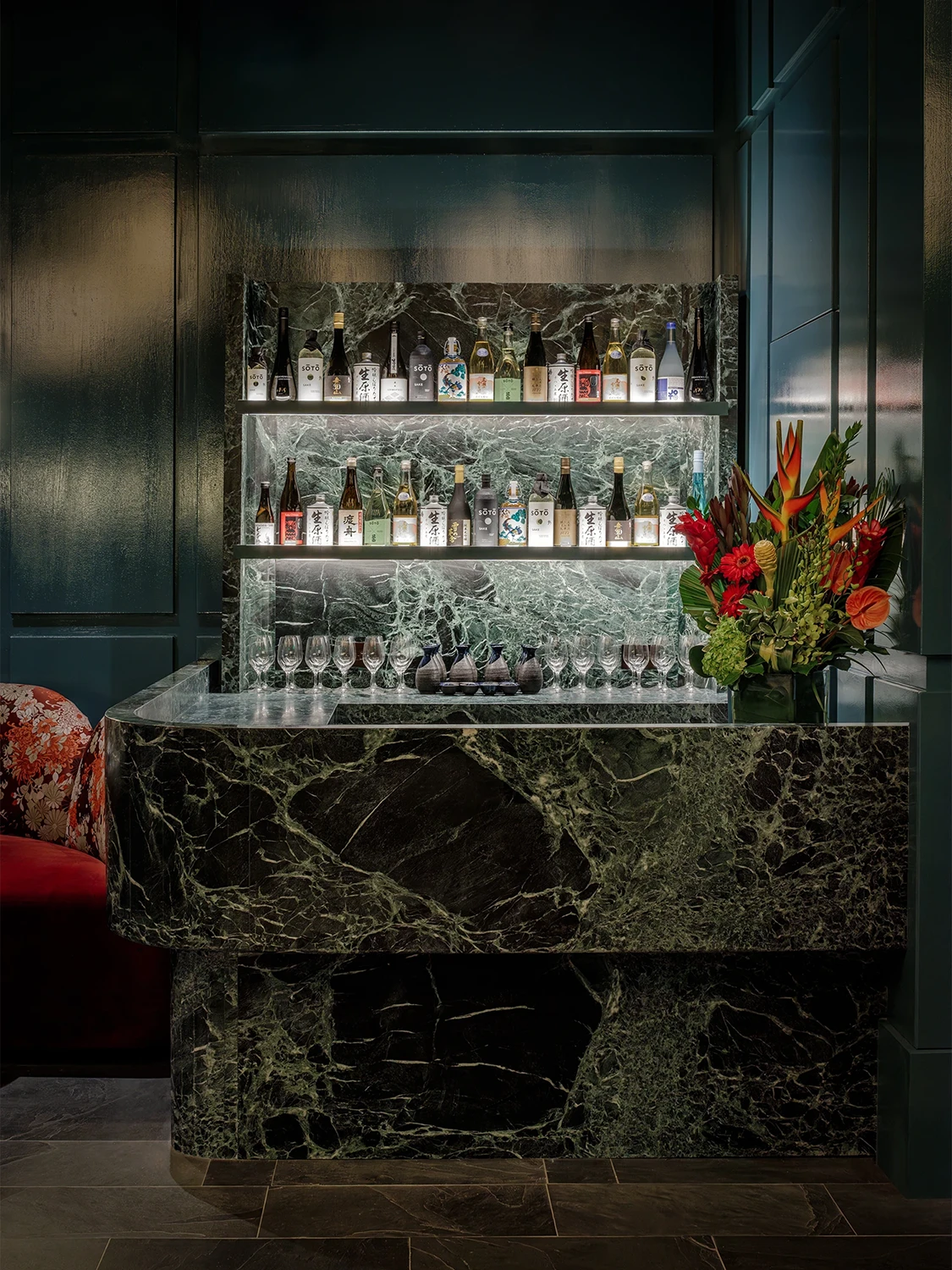 A solid marble bartop in front of a full bar at the Japon Setai Hotel